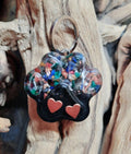 Secret Synergy Stones EMF 5G protection pet charm with paw print design, collar charm for pets, black and silver color.