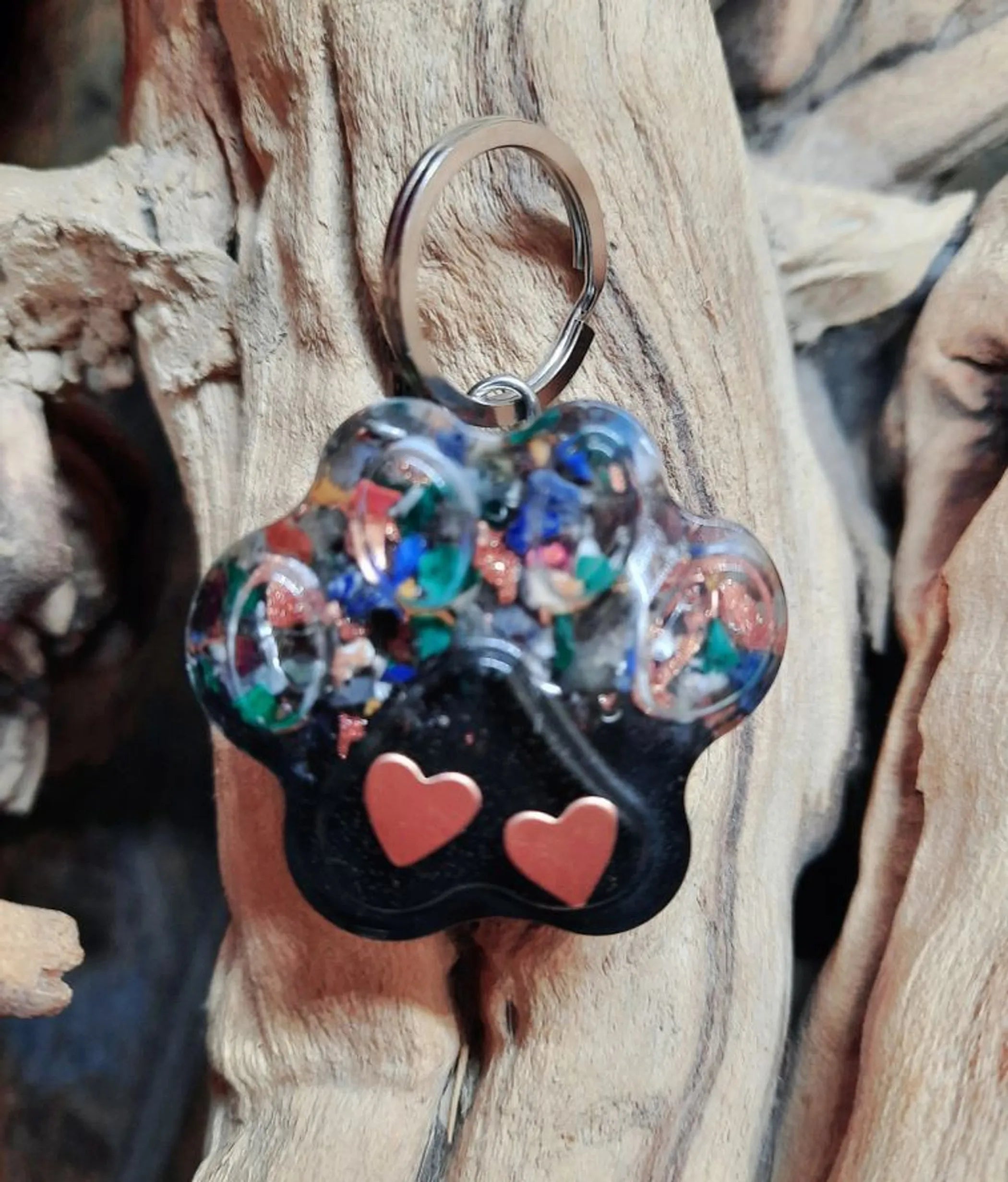 Secret Synergy Stones EMF 5G protection pet charm with paw print design, collar charm for pets, black and silver color.