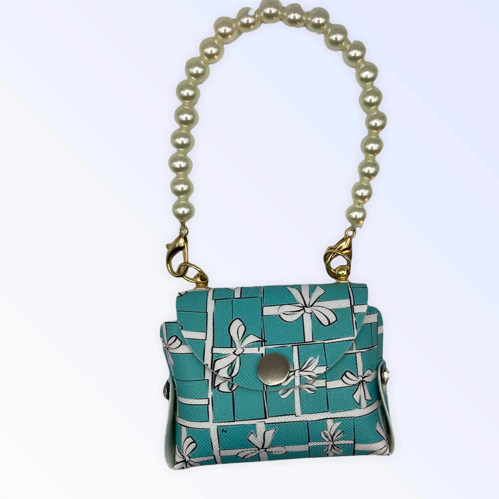 Dog clothes featuring a Pearl Handle Sniffany Pick Up Bag from Bark Fifth Avenue, with the bag's pearl handle and stylish design visible.