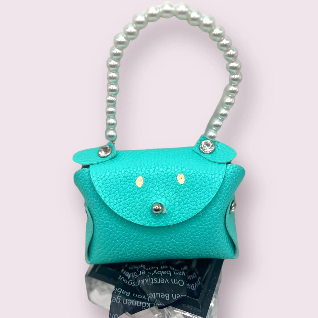 Bark Fifth Avenue Sniffany Puppy Pick-Up Bag Carrier treat bag with adjustable strap and dog-themed design in a clear image.