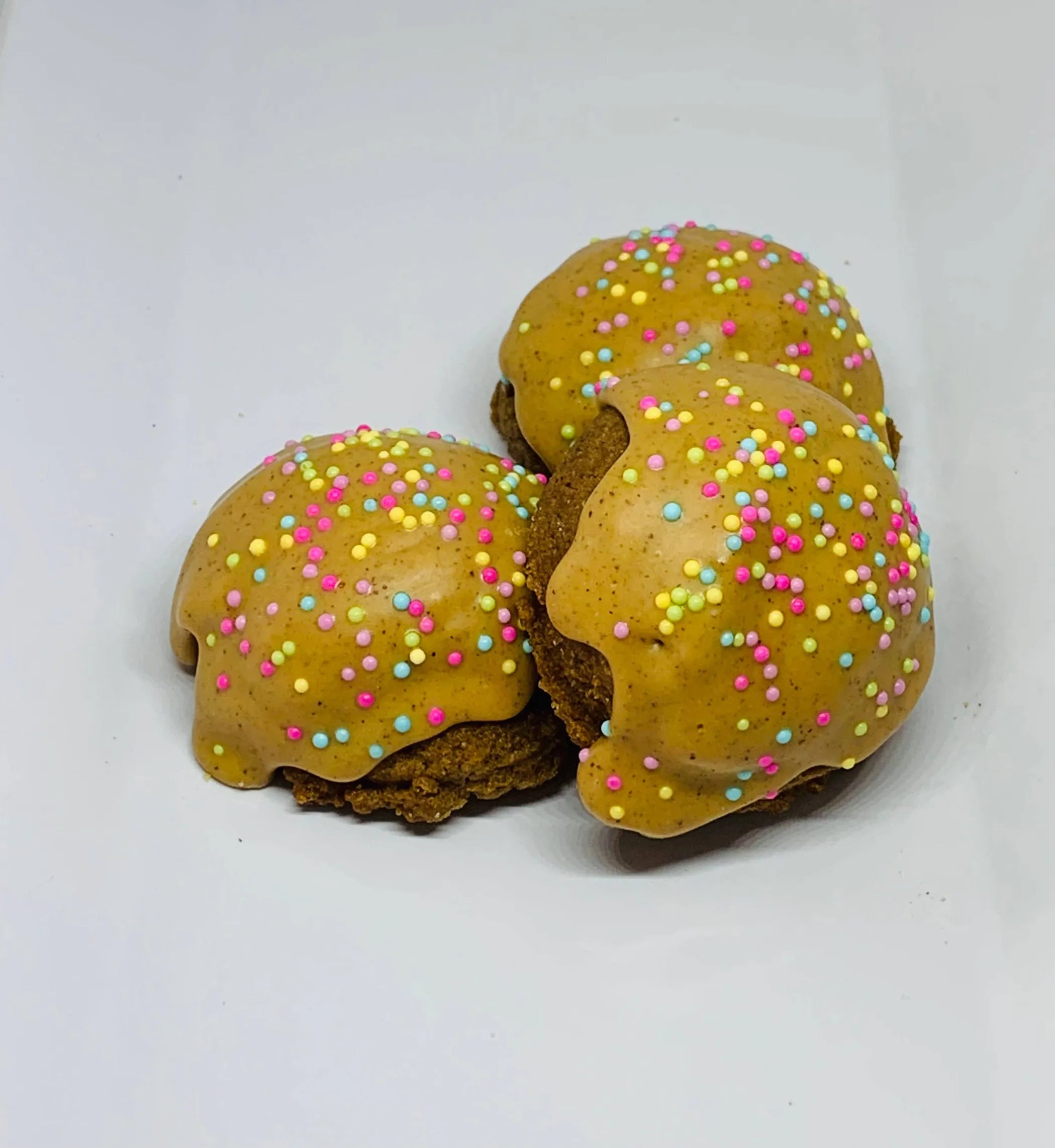 Dog treats from The Blue Cerebus Bakery, Reese Cake Balls with gourmet peanut butter flavor for dogs, shown in a close-up image.