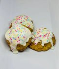 Snicker'Poodle Cake Balls dog treats by The Blue Cerebus Dog Bakery, featuring small, colorful treats for dogs on a white surface.