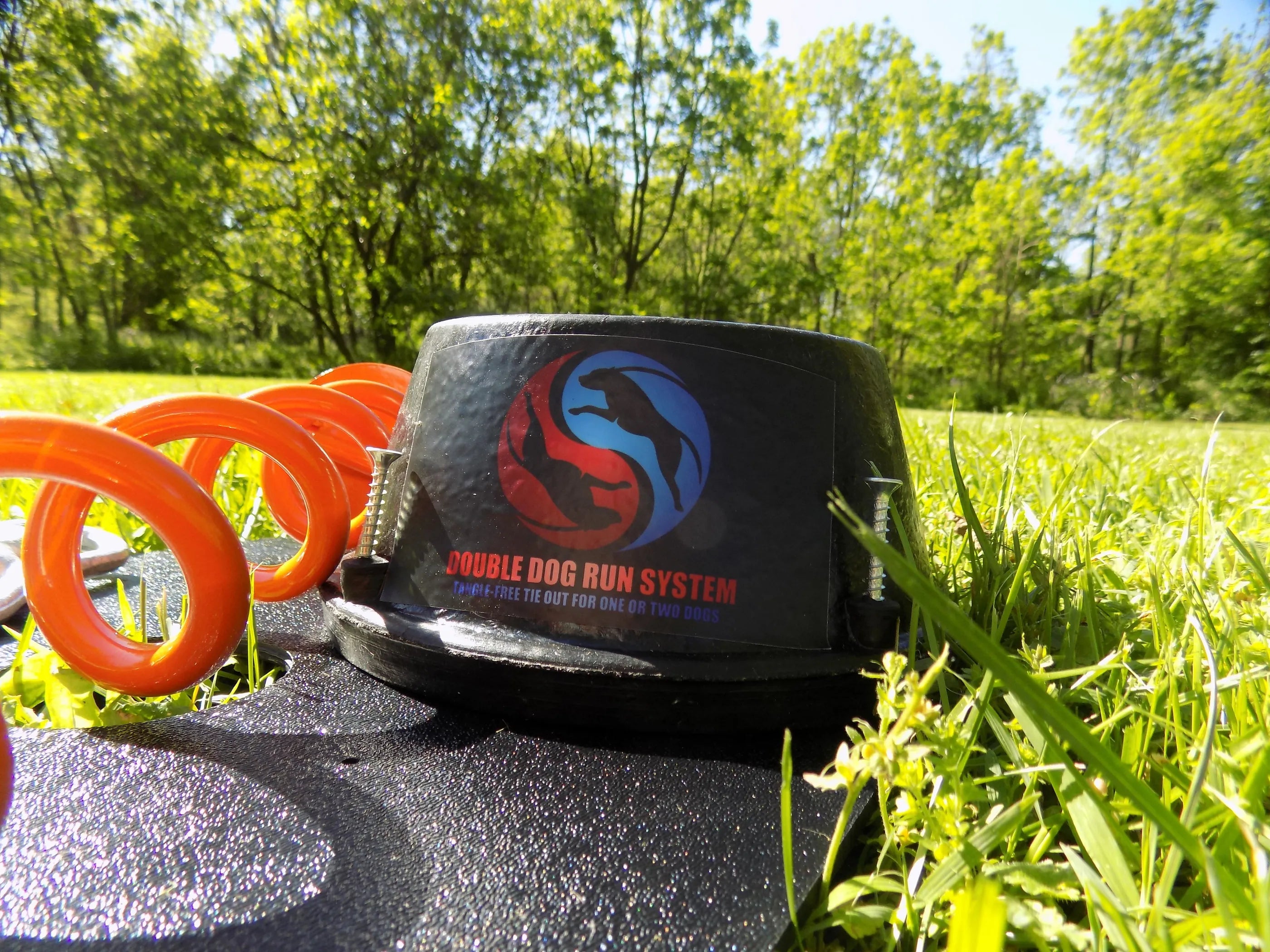 Infinitely Tied double dog run tangle-free tie out stake with two leashes, ideal for securing two dogs outdoors.