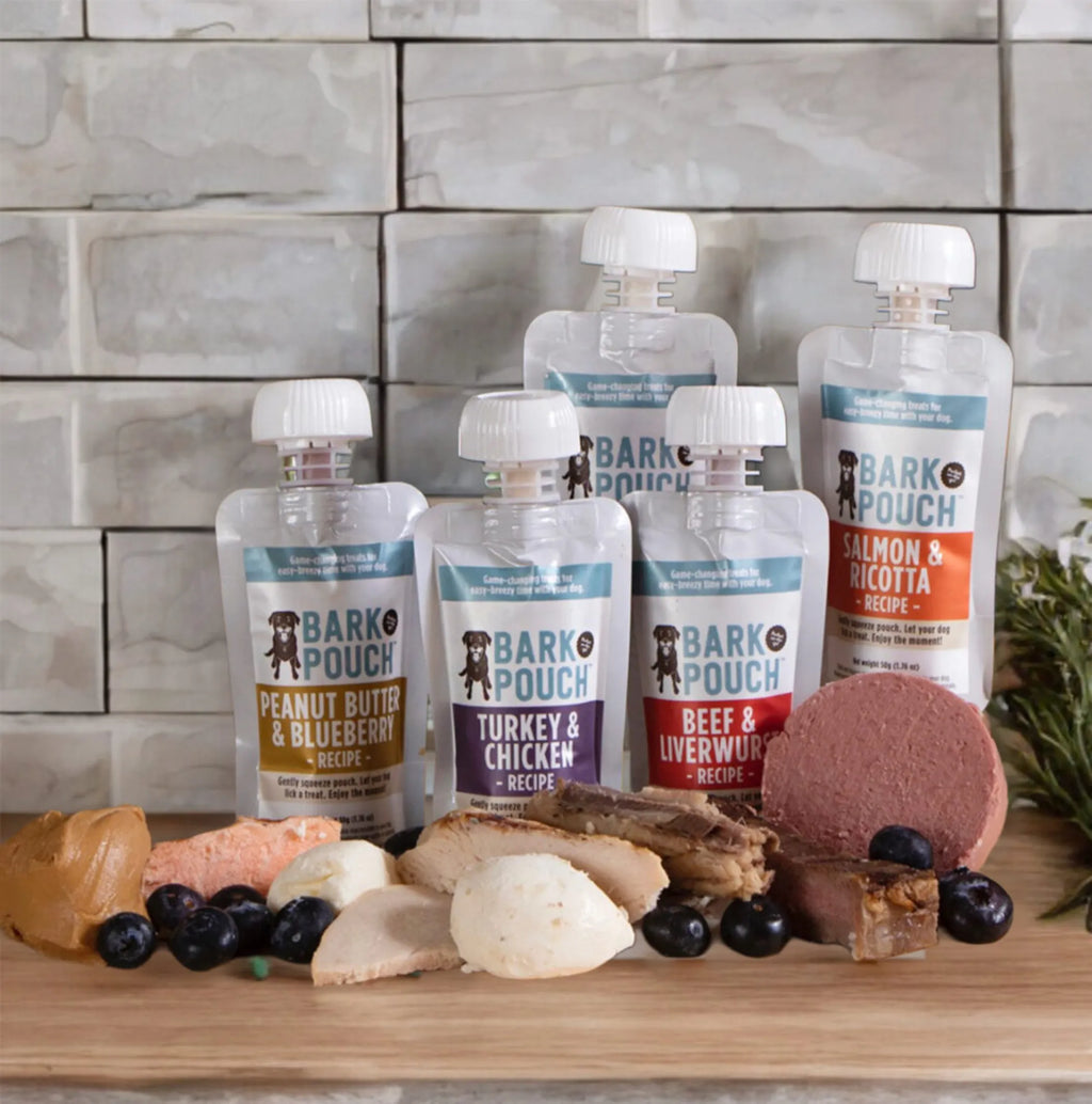Five pack of Bark Pouch lickable dog treats, featuring colorful packaging and treats for dogs.