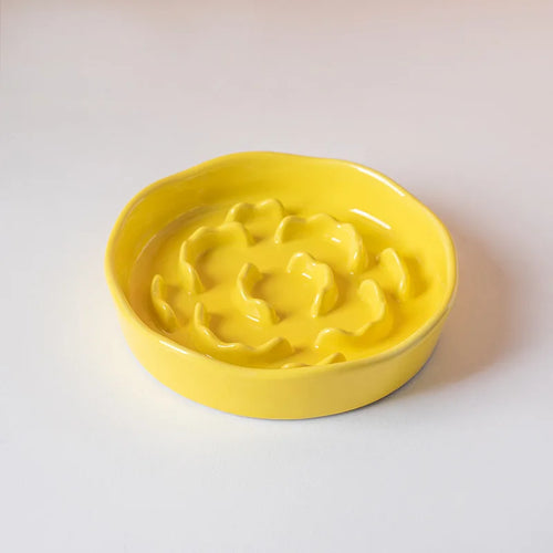 White ceramic slow food cat bowl with high footed design and neck protection, ideal for preventing neck strain during feeding.