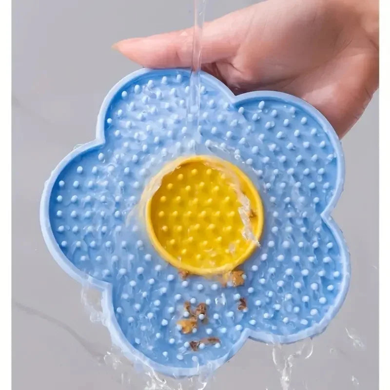 Blue silicone pet licking mat for dogs and cats, sunflower shape slow feeder bowl for pet enrichment and calming.