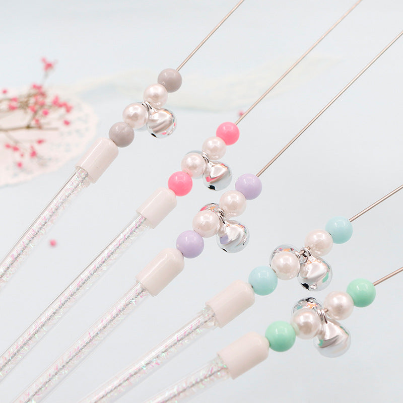 Colorful pom pom cat teaser wand with bell toy from Brandywines Time, featuring a grey handle and vibrant pom poms for playful fun.