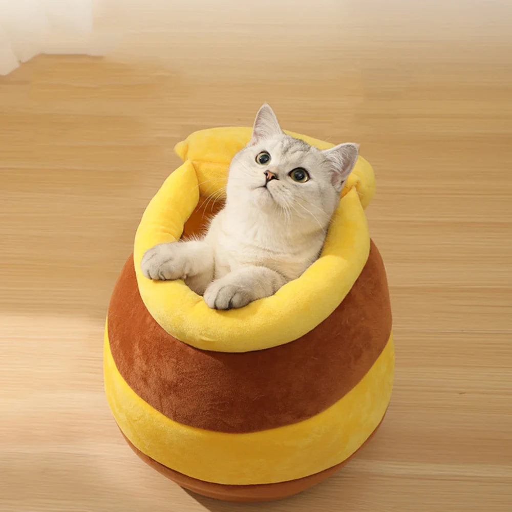 Yellow Pandora honey jar-themed cat bed with soft fabric and cozy interior, perfect for small cats or kittens.