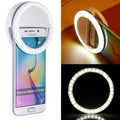 Yellow Pandora portable selfie ring clip-on attached to a mobile phone, providing enhanced lighting for photos.